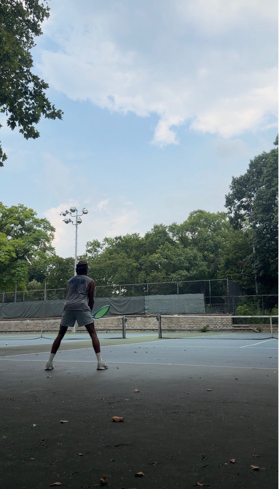 Prem on a public tennis court